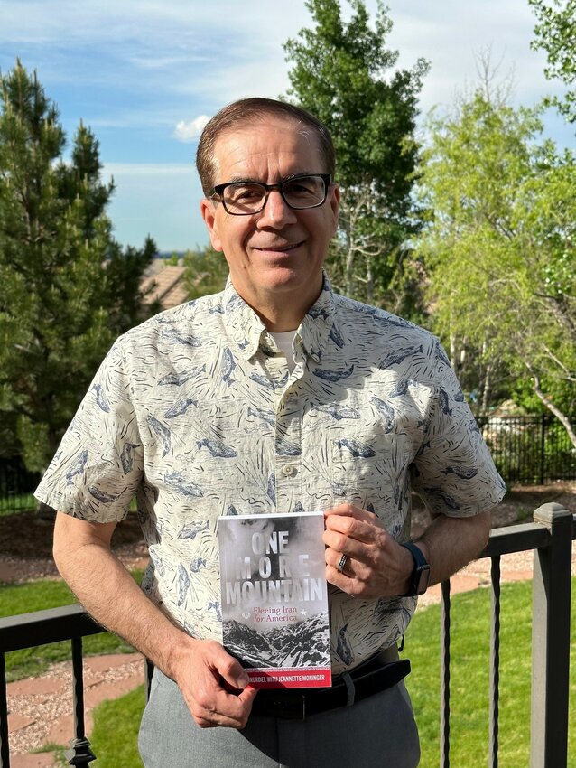 Dr. Mansur Nurdel with his book, "One More Mountain".
